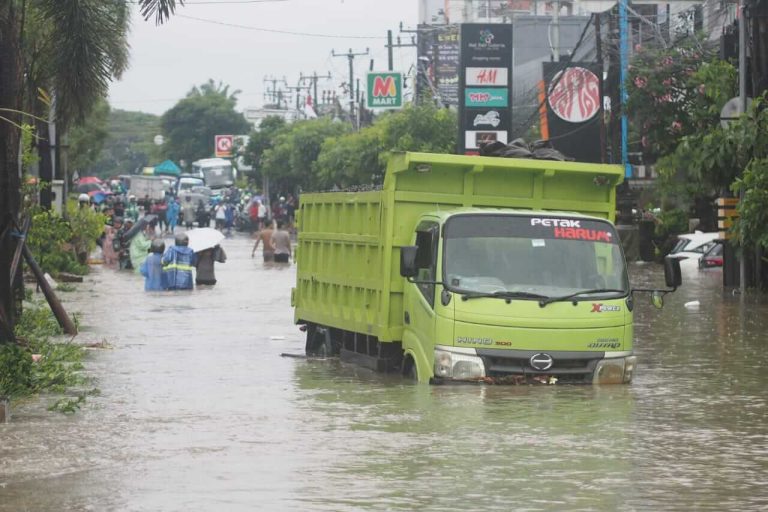 Truk melintasi genangan banjir setinggi paha orang dewasa di Bali.