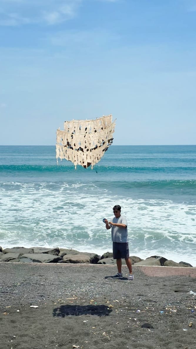 Kadek Armika membuat layang-layang tradisional Bali, merangkai bahan dengan teliti sebagai wujud pelestarian budaya dan kreativitas.