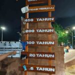 Papan informasi edukasi waktu penguraian sampah di Pantai Kuta, Badung tentang pentingnya menjaga lingkungan