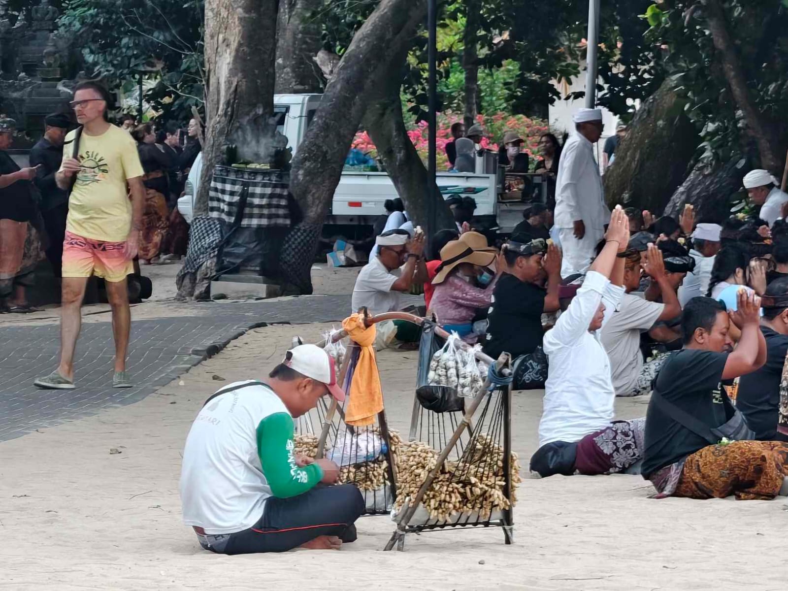 Umat berdoa sementara pedagang menunggu pembeli di sekitar lokasi ibadah